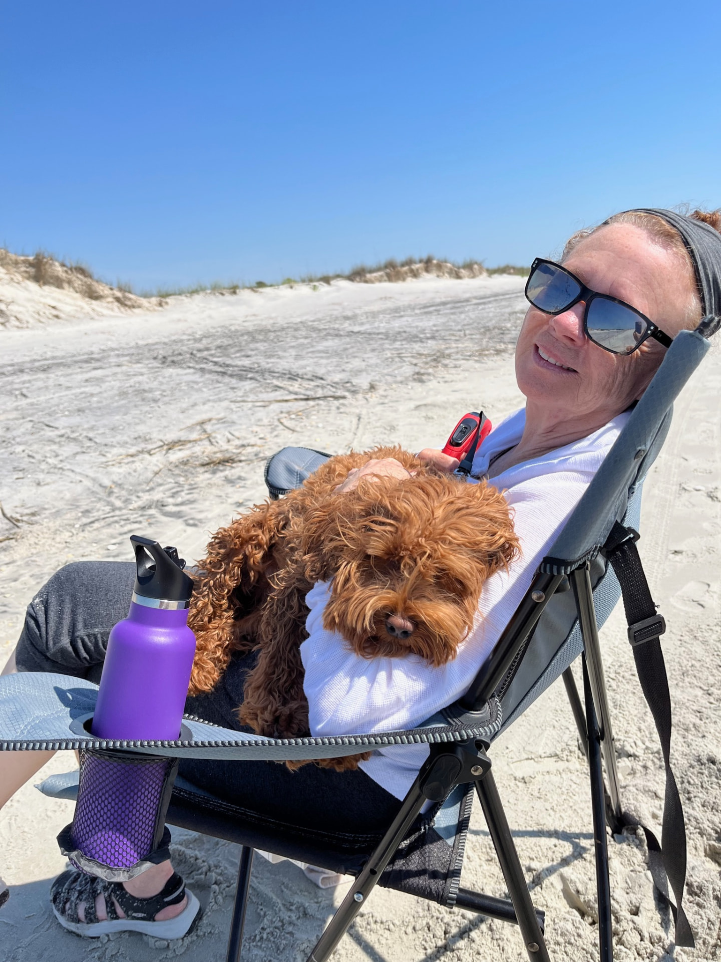 Pamela Zinck, founder of Pamela Zinck Aromatics, relaxing outdoors with her dog