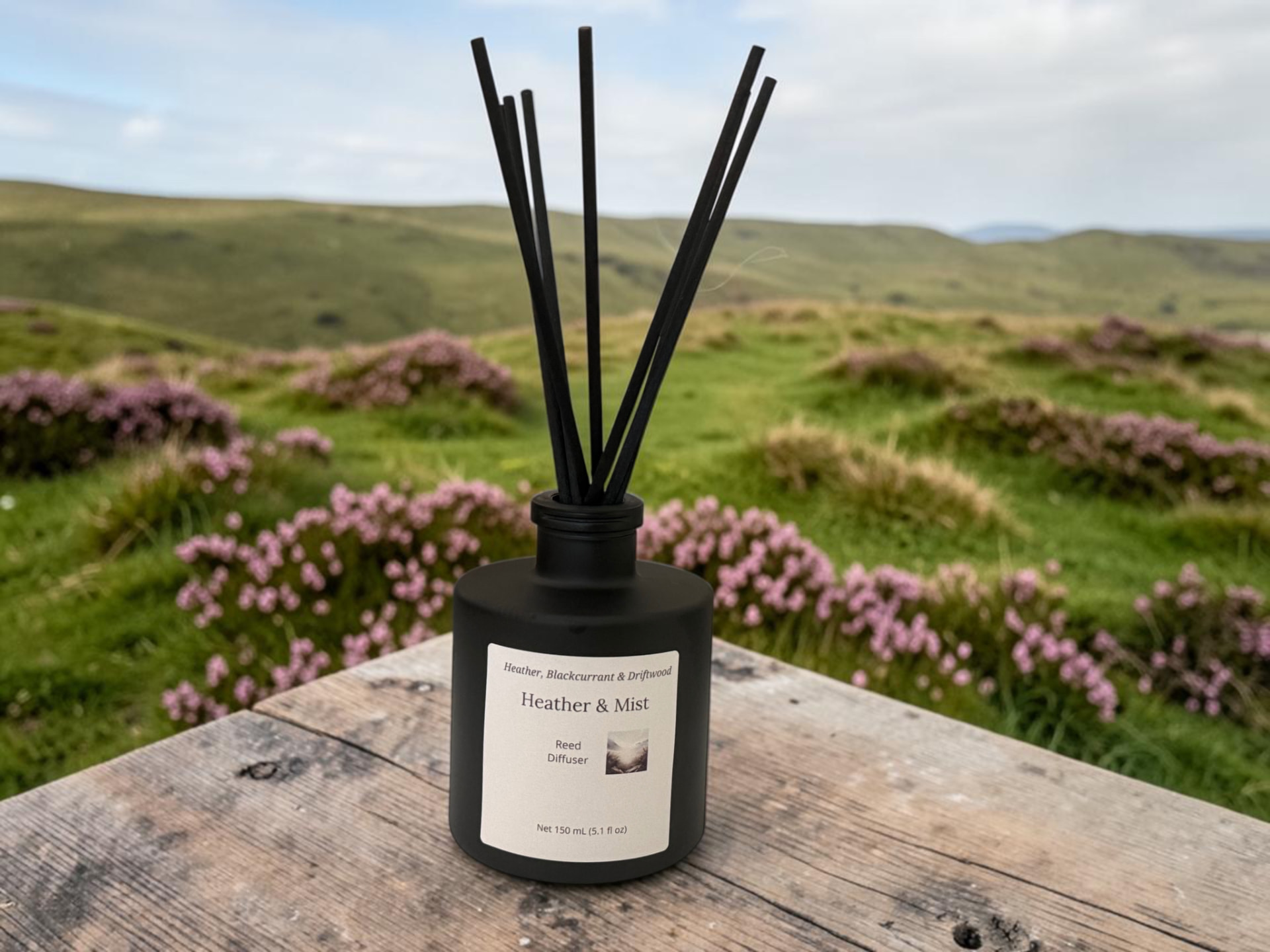 Heather & Mist Reed Diffuser, a matte black bottle with black reeds set against a misty heather landscape