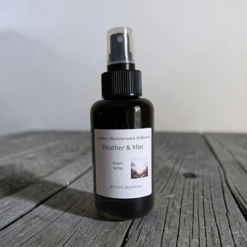 Heather & Mist Room Spray, a black spray bottle with a clear cap on weathered gray wooden planks