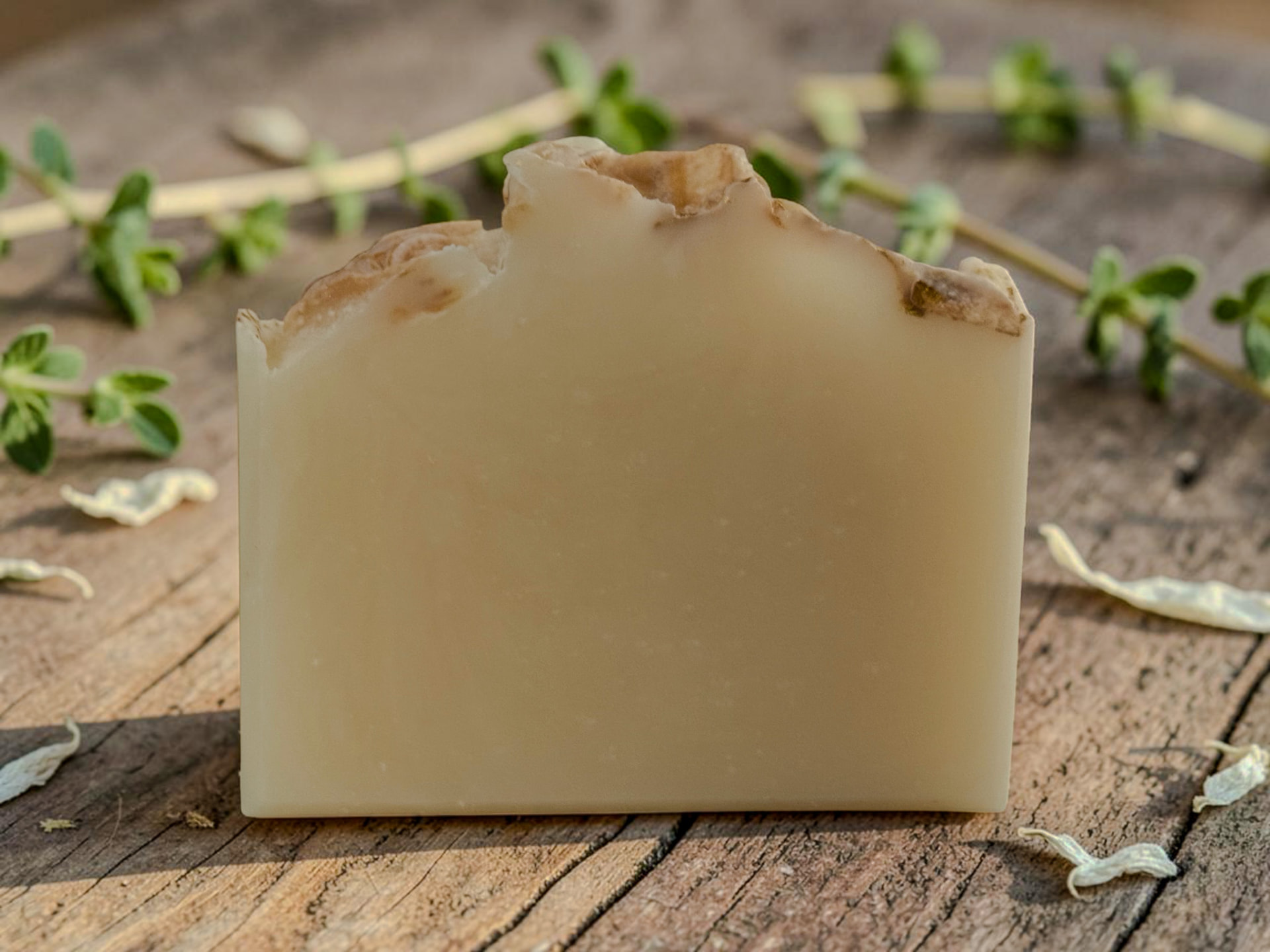 White Tea & Thyme Soap, a creamy handmade bar with fresh thyme sprigs and white tea leaves